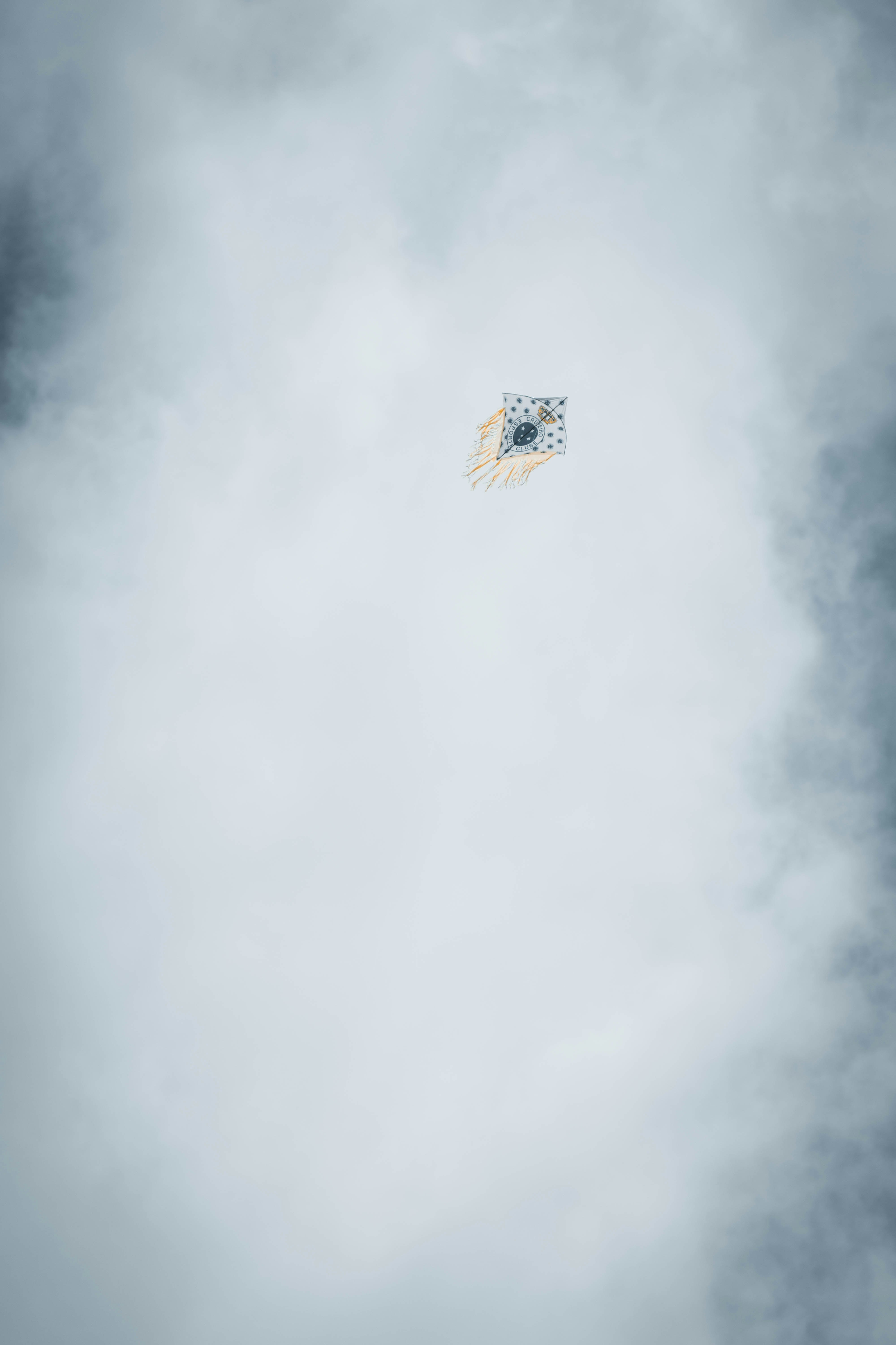 blue and yellow flag on white clouds